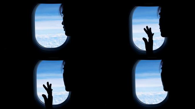 女人透过飞机窗户看