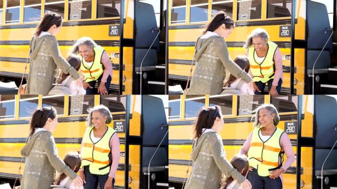 快乐的校车司机在女孩上车前与小女孩和她的妈妈交谈