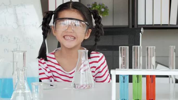 教育主题: 有趣的小女孩在实验室做实验。科学与教育。
