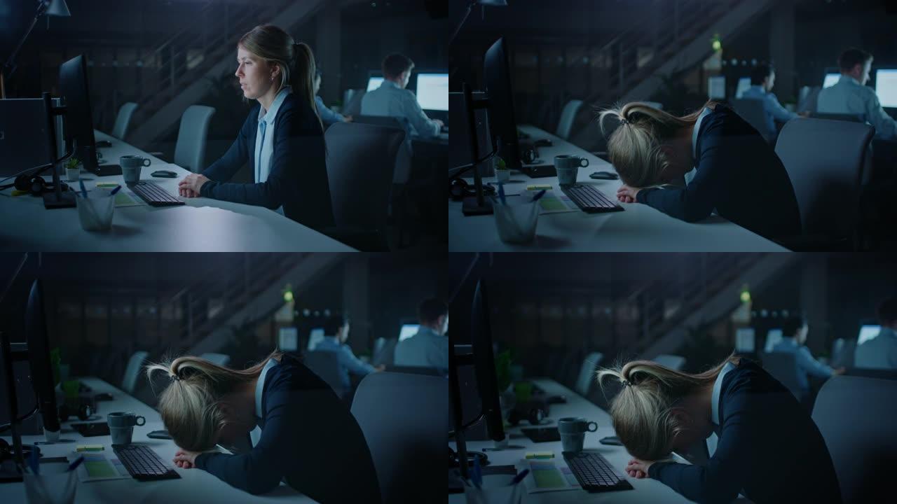 晚上在办公室过度劳累的女上班族绝望地使用台式电脑摔倒在手上睡着了。疲惫疲惫的女商人完成重要项目