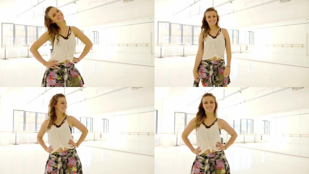 自信的年轻女子站在舞蹈工作室