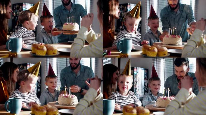 年轻的父亲为高加索小儿子带来生日蛋糕，与家人慢动作一起在家里庆祝有趣的聚会。