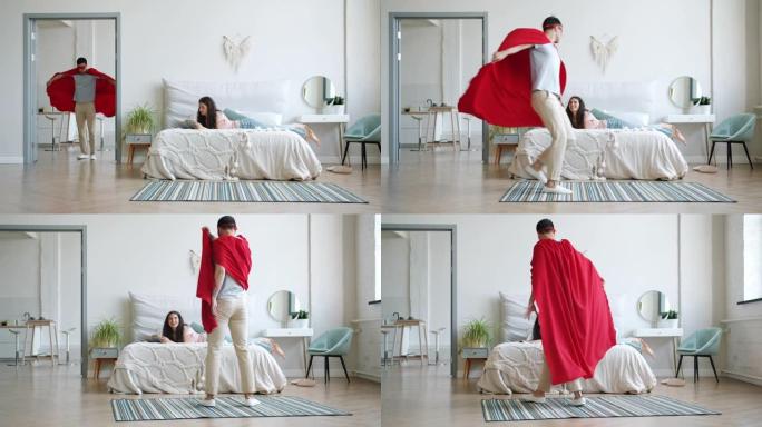 穿着超级英雄服装的男人跑进房间，女孩在床上看书