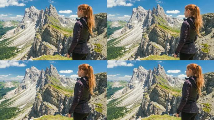 意大利多洛米蒂的塞塞达山上的女人看着令人叹为观止的景色