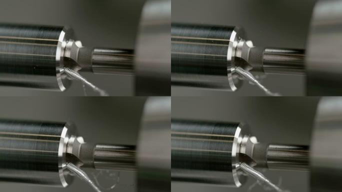 宏观，dow: 锋利的钻头在闪亮的铝棒中间钻一个孔。
