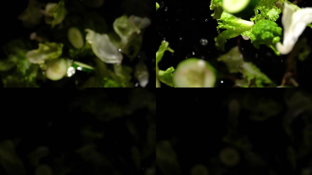 飞溅的绿色沙拉飞向相机的慢动作
