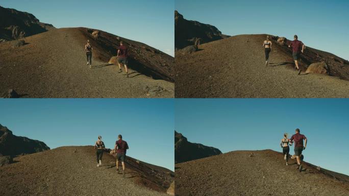 出去跑!年轻夫妇徒步运动跑步山顶山峰火山
