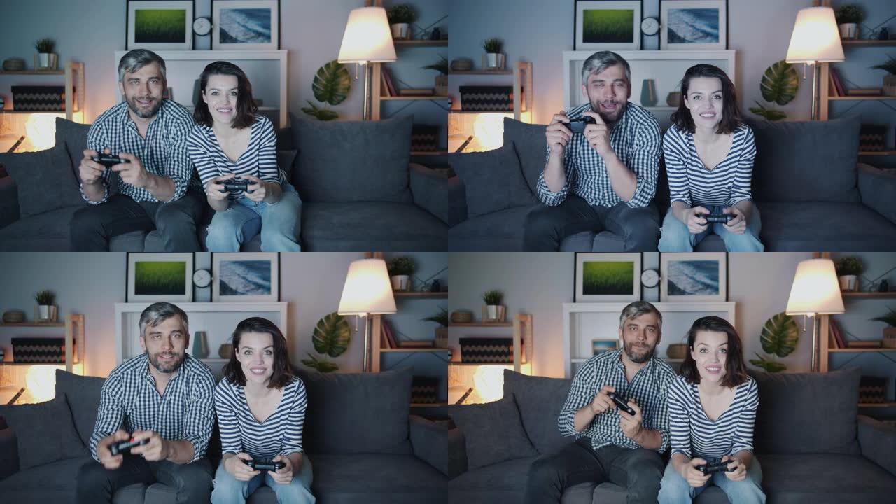 幸福夫妻男女深夜在家玩电子游戏微笑