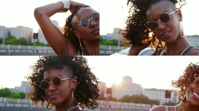 在黄金时段，戴着墨镜的年轻黑人妇女在伦敦的一条街道上看着相机