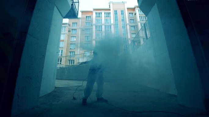 一个人在为街道消毒时使用喷雾器。