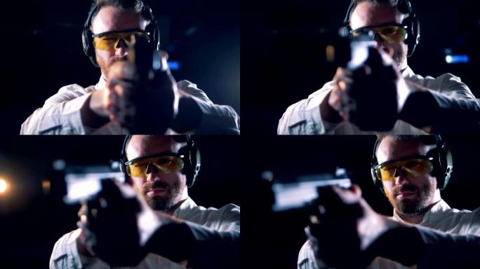 戴眼镜的人在射击室拿着枪，特写镜头。