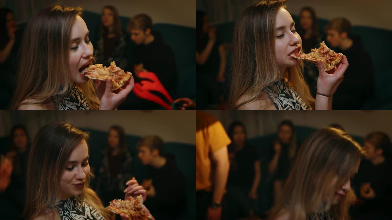 十几岁的女孩在派对上享受披萨时跳舞