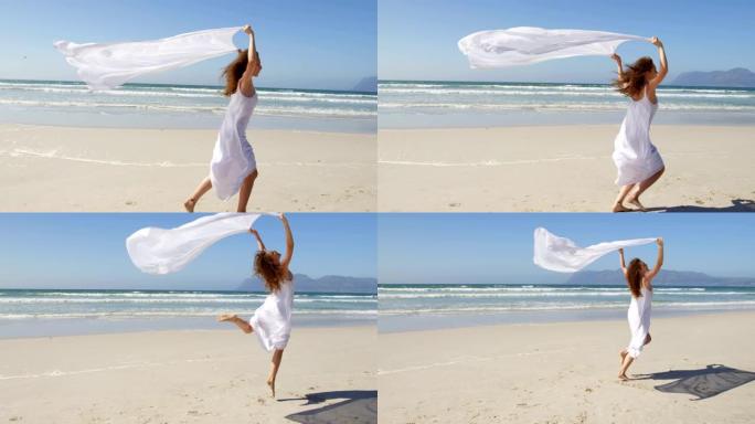 女人在海边奔跑，戴着等待的围巾。在海滩4k