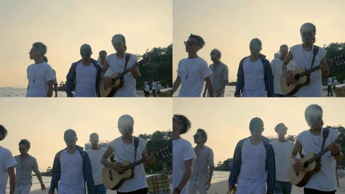 年轻的亚洲成年男子在沙滩上散步唱歌和弹吉他
