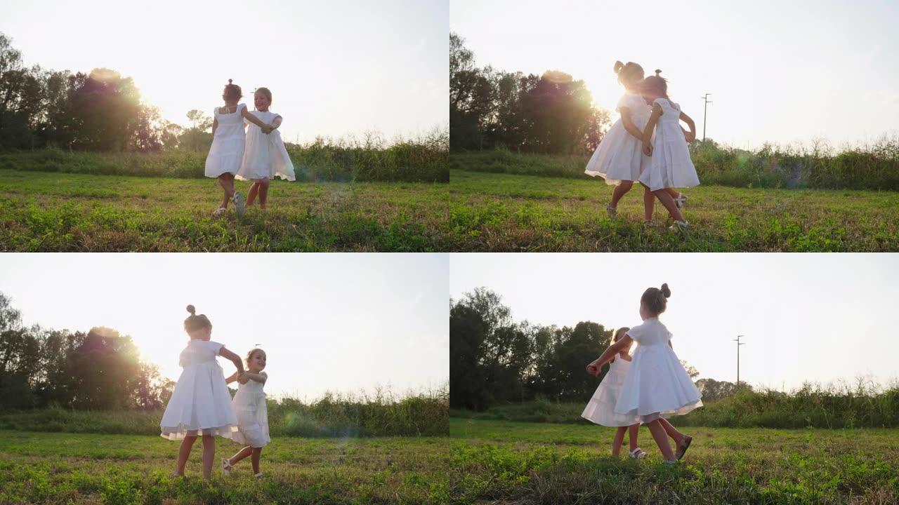 两个可爱的快乐无忧无虑的小女孩的真实照片姐妹们在阳光明媚的日子里拥抱和享受她们在大自然中的时光