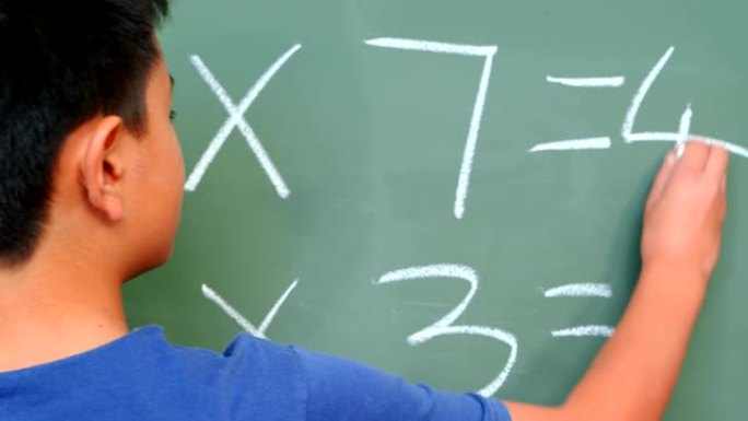 4k学校教室里用黑板解决数学问题的亚洲男生后视图