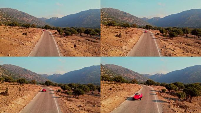 红色汽车在沙漠道路上行驶，鸟瞰图