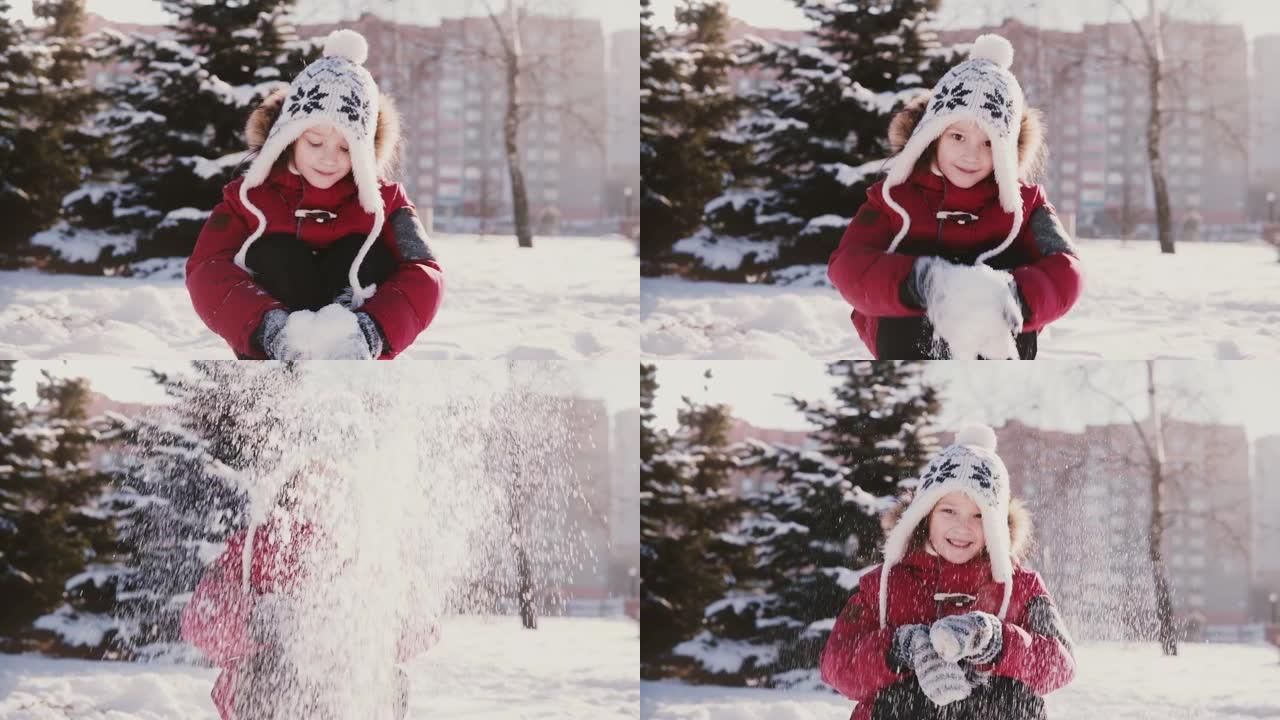 穿着冬装的可爱的小快乐欧洲女孩看着相机，向空中扔雪，微笑着慢动作。