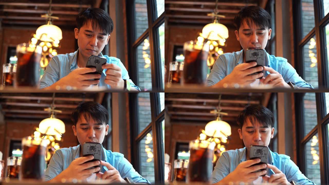 亚洲年轻人在餐厅使用智能手机
