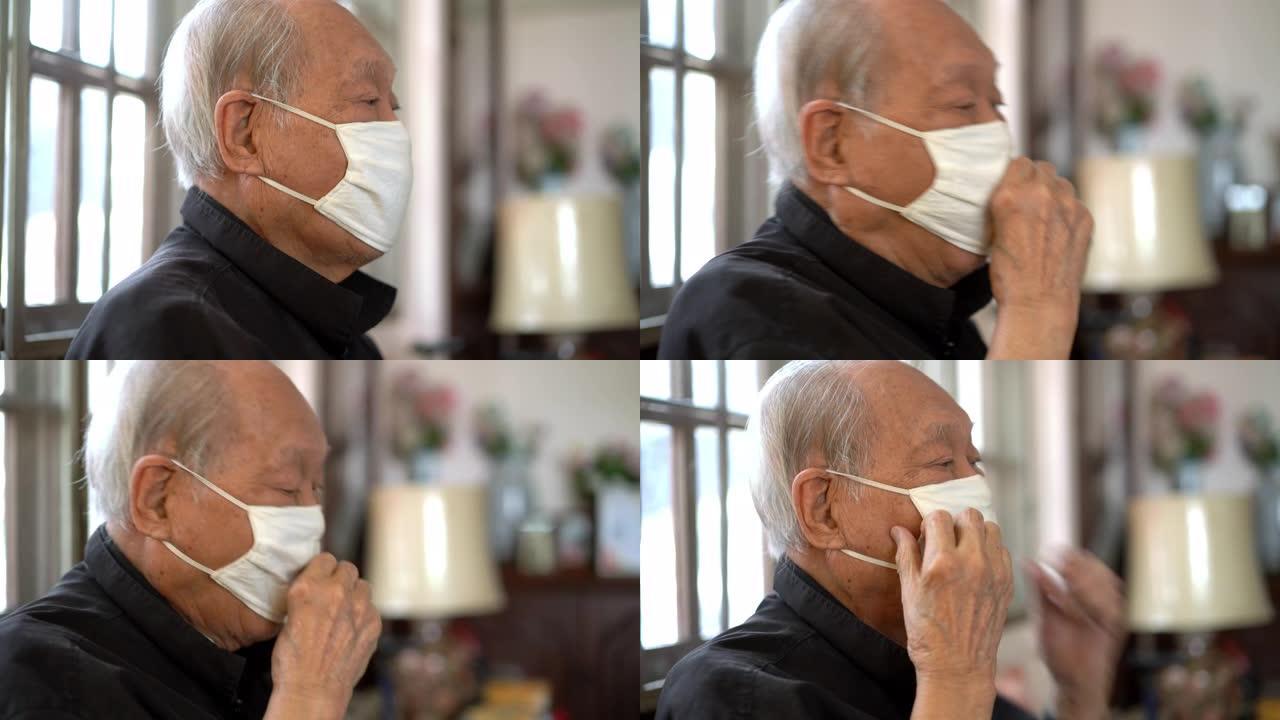 资深亚裔男子戴口罩在家咳嗽