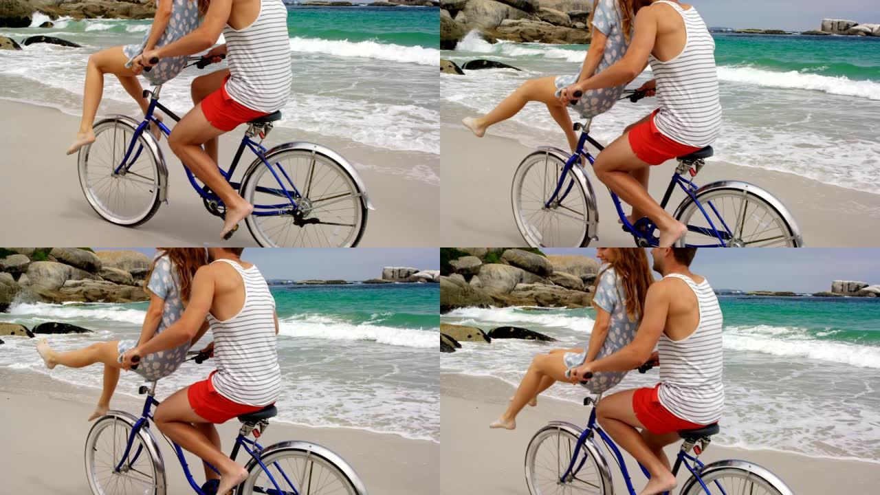 高加索夫妇在海滩上骑自行车的侧视图4k