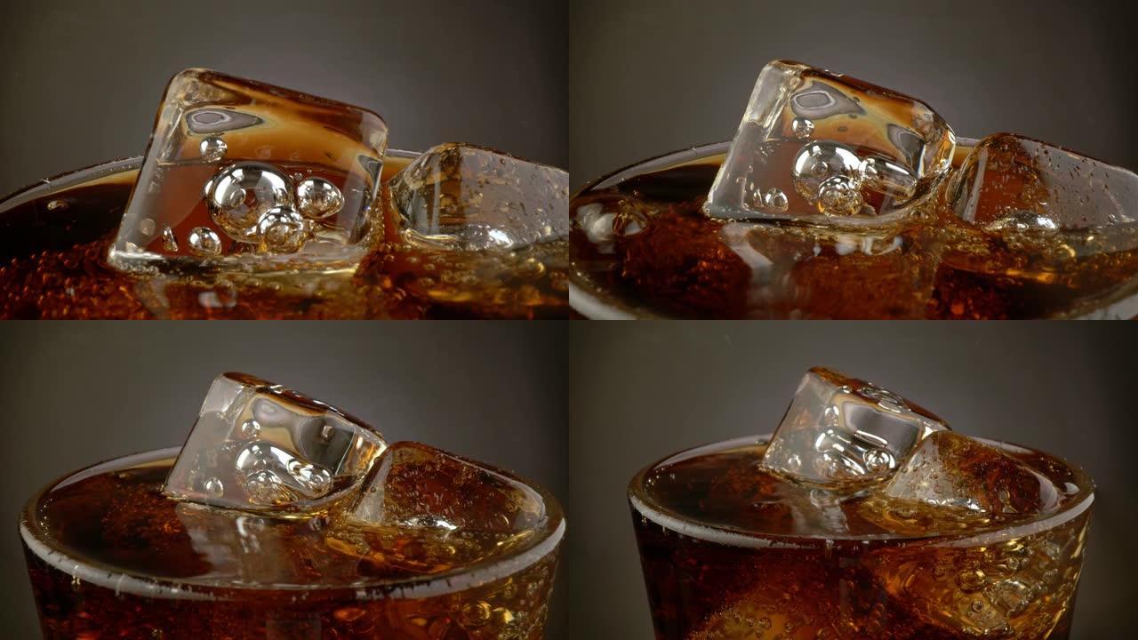 旋转玻璃杯配可乐碳酸饮料和冰块。黑暗背景。4K