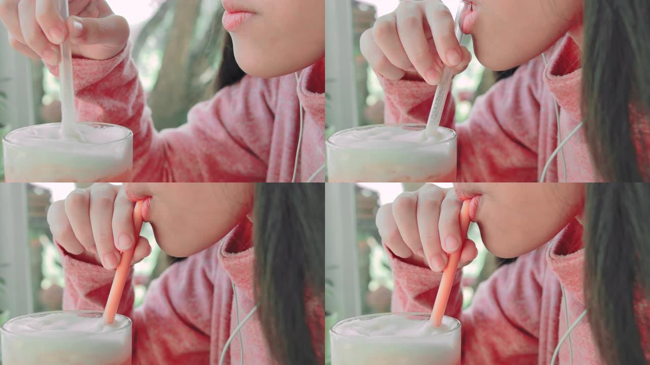 SLO MO小女孩用吸管喝果汁