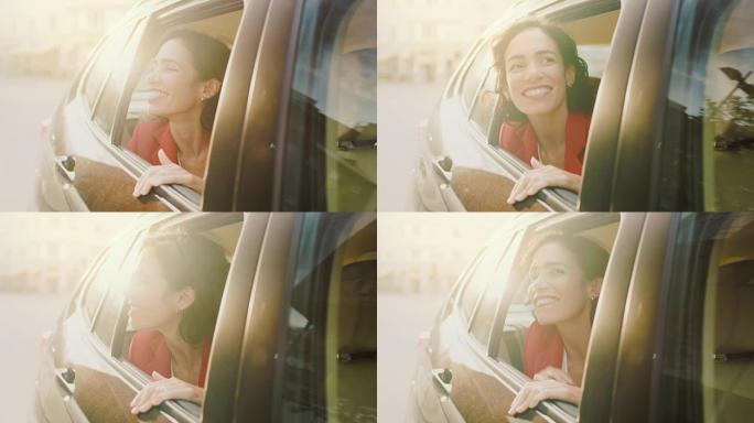 快乐美丽的女人坐在汽车后座上，惊奇地看着窗外。旅行女孩体验世界的魔法。从车外拍摄的相机。