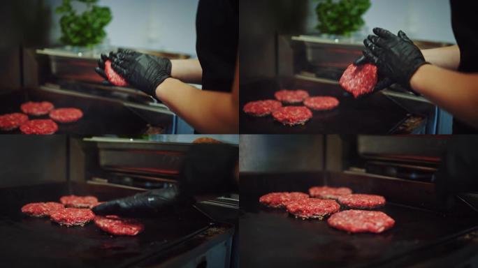 在烤架上准备肉饼的美味特写镜头。新鲜的碎牛肉被放在热气或电烤架上。库克正在用新鲜的碎肉制成汉堡肉饼。