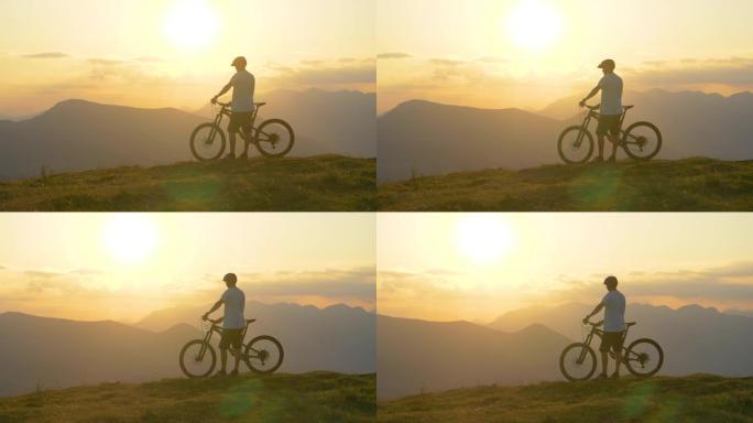 慢动作: 年轻的男性游客在骑山地自行车之前观察风景