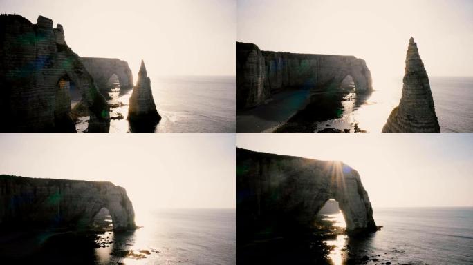 长空中天桥拍摄，著名的白色悬崖在史诗般的日落诺曼底海岸，有天然的岩石拱门和平静的海浪。