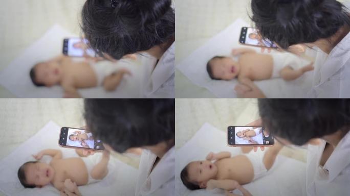 妈妈给男婴拍照妈妈给宝宝拍照婴幼儿小婴儿