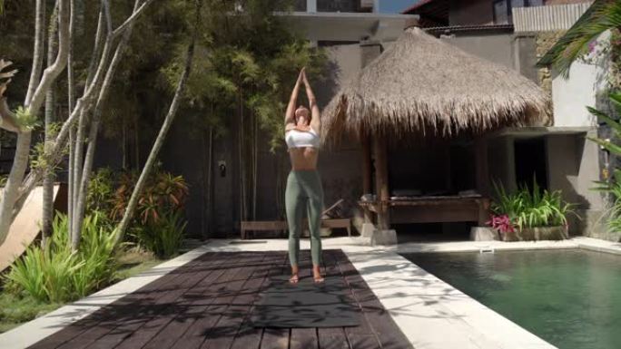在后院热带花园中做瑜伽的女人的镜头序列