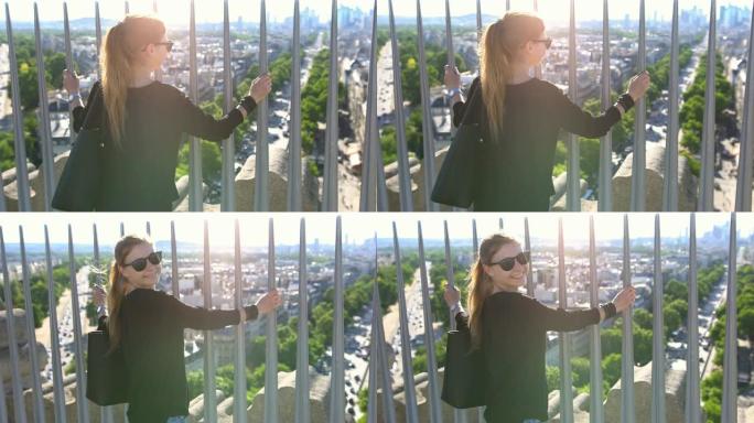 巴黎凯旋门顶上的游客俯瞰着这座城市，在阳光明媚的日子里对着镜头微笑
