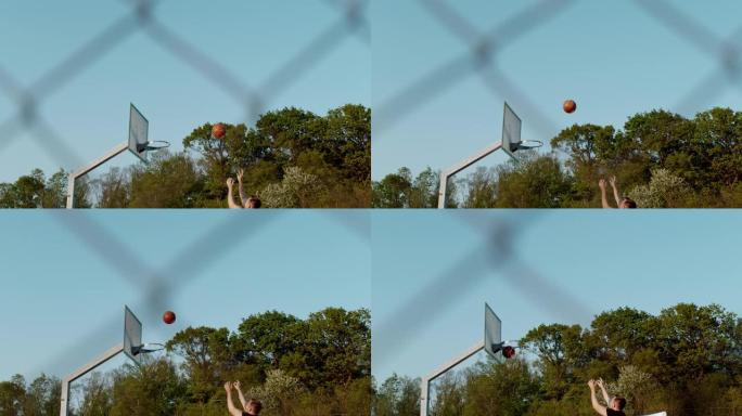 MS超级慢动作男子在室外篮球场上射击篮筐