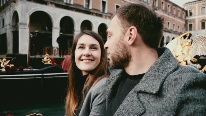快乐的年轻兴奋的高加索新婚夫妇在贡多拉享受意大利威尼斯运河之旅的特写镜头