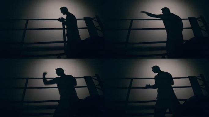 一个男人在黑暗中拳击的影子