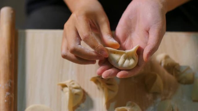 女人手包饺子