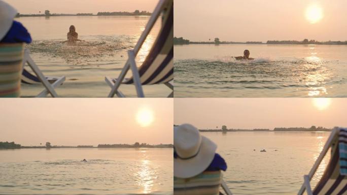 日落时分，狂喜的女人在湖里游泳