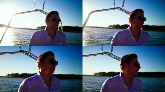 湖上阳光明媚的下午。享受帆船运动的年轻人