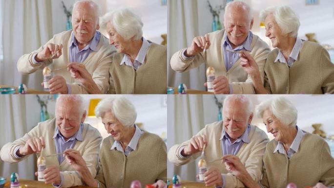 快乐的老年夫妇画鸡蛋