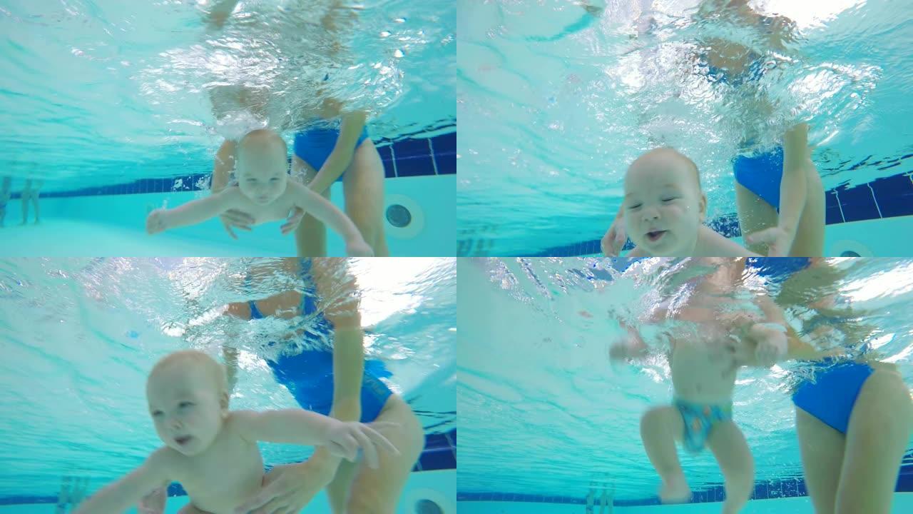 一个婴儿在游泳池的水下潜水。水下射击。