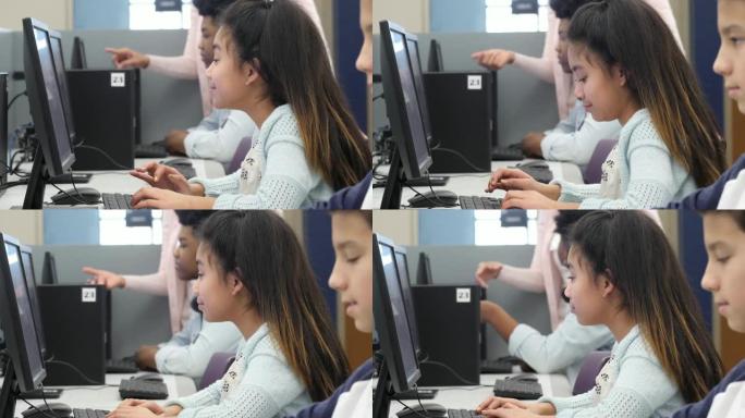 小学生在计算机实验室集中精力