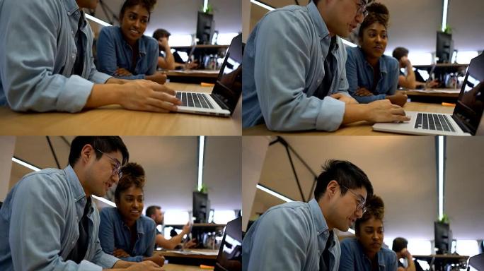 在一个项目中工作的多元化合作伙伴一起聊天，看着笔记本电脑的屏幕