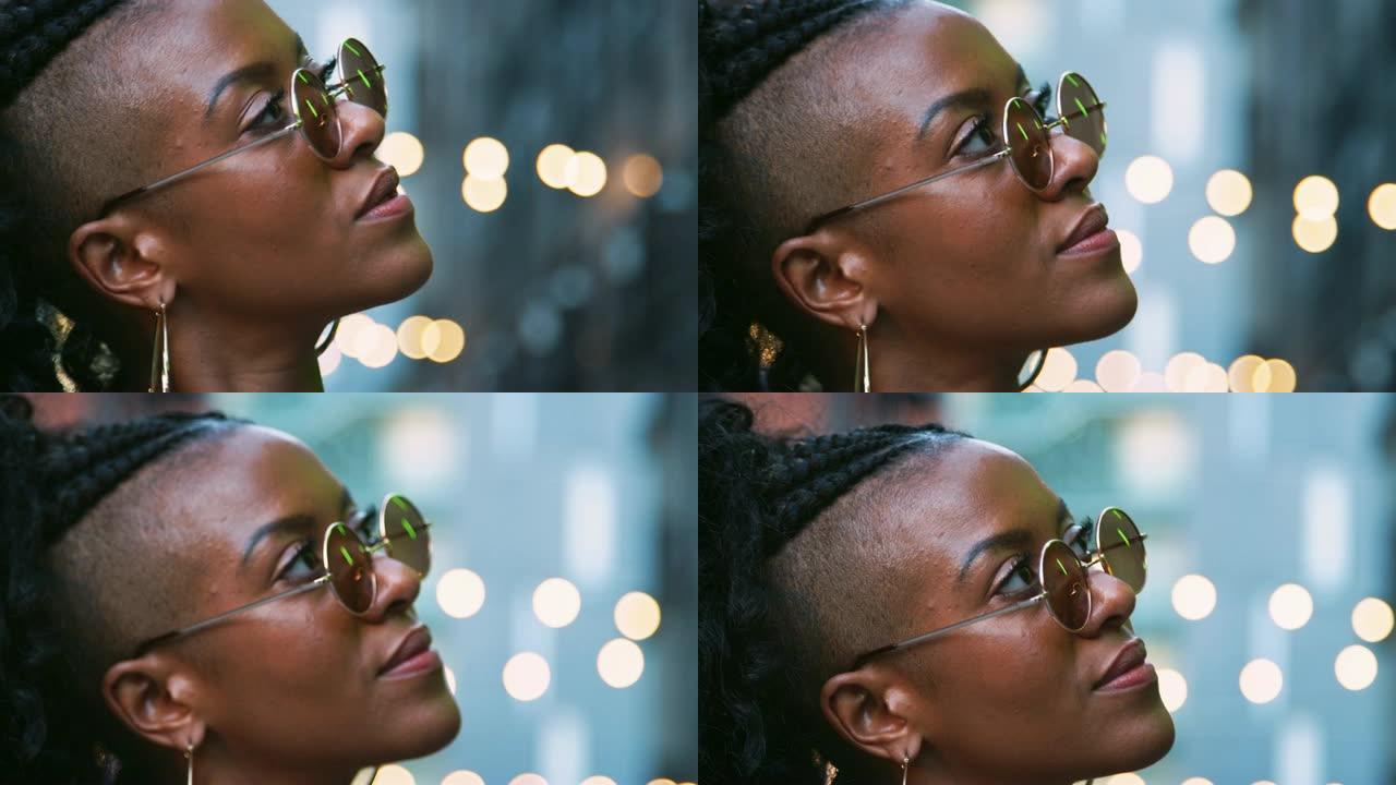 时尚的年轻黑人女性戴着太阳镜，头部拍摄，侧视图，背景中的bokeh灯