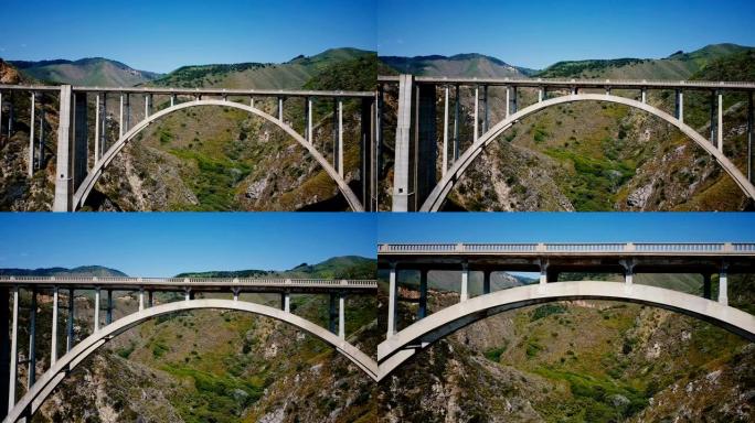 无人机正飞行在大苏尔美国著名旅游目的地1号高速公路的标志性著名比克斯比溪桥下