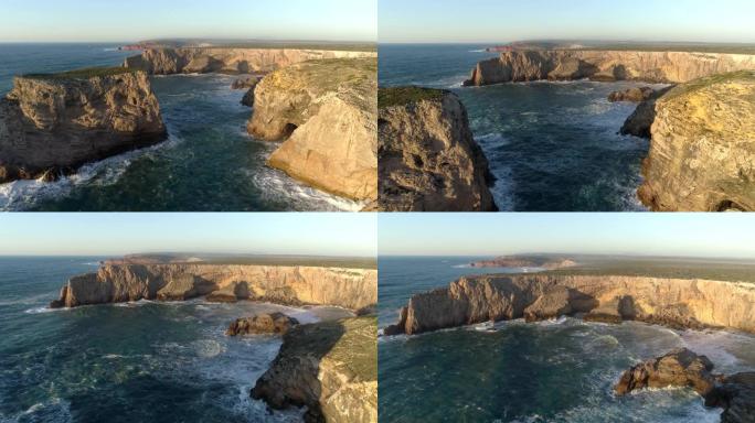 在葡萄牙圣文森特角 (Cabo de Sao Vicente) 飞越挥舞着大西洋和覆盖着绿色苔藓的黄