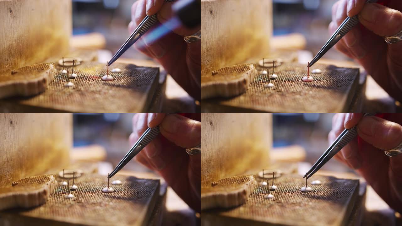 工作室女性珠宝商焊接耳环的特写