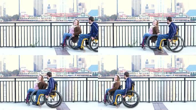 在城市海滨坐轮椅的夫妇