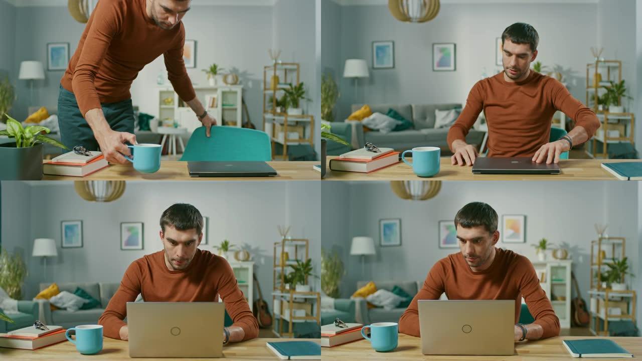 家里英俊的年轻人的肖像，坐在办公桌前，开始在笔记本电脑上工作。清晨在自由职业者的客厅里工作。